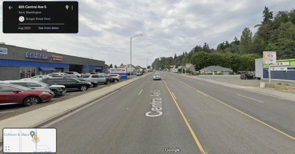Street View image of a street with five lanes and sidewalks but no bike lanes.